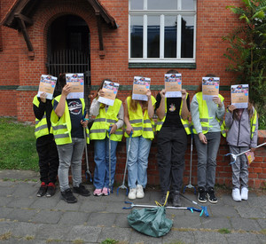 Auf diesem Bild sieht man eine Schülergruppe mit Urkunden vor dem Hauptgebäude.